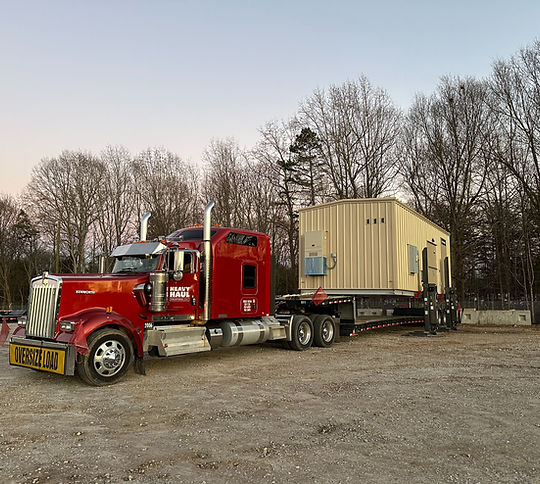 Heavy haul truck transporting modular unit