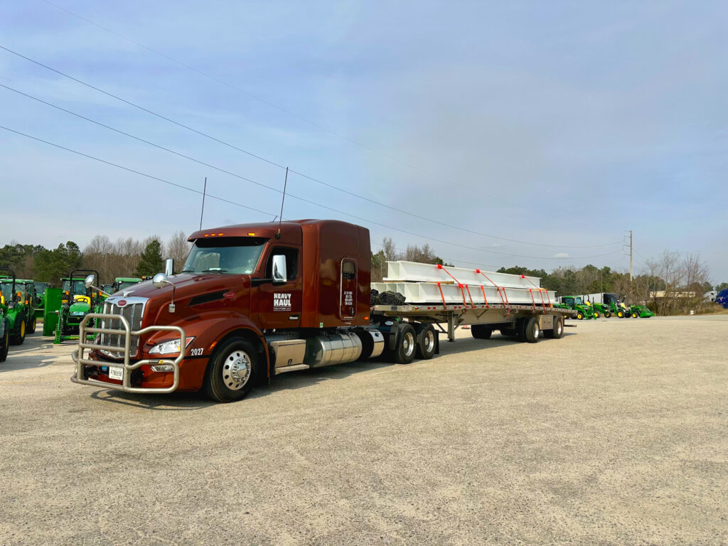 Flatbed semi truck carrying construction materials - 3PL carrier