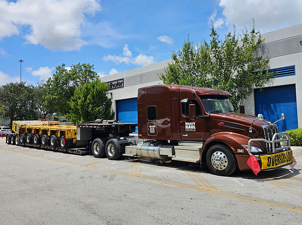Fleet vehicle on lowboy trailer